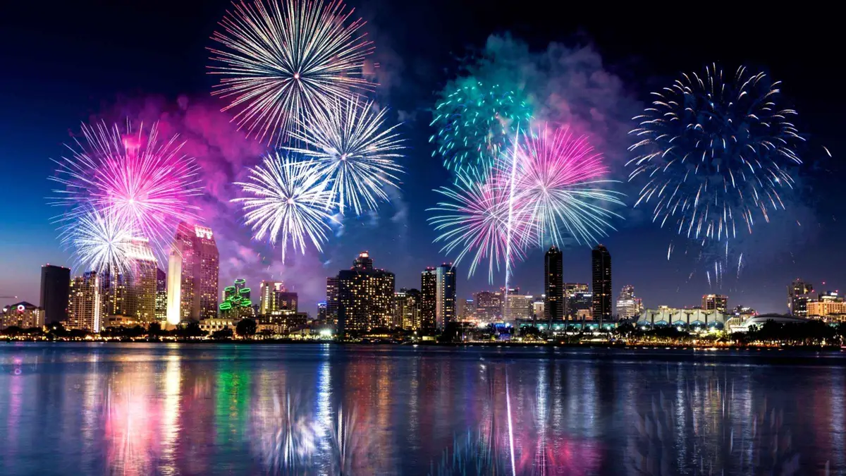 Fireworks over Waikiki watched from a cruise boat on an Oahu boat tour at night, Honolulu, Hawaii